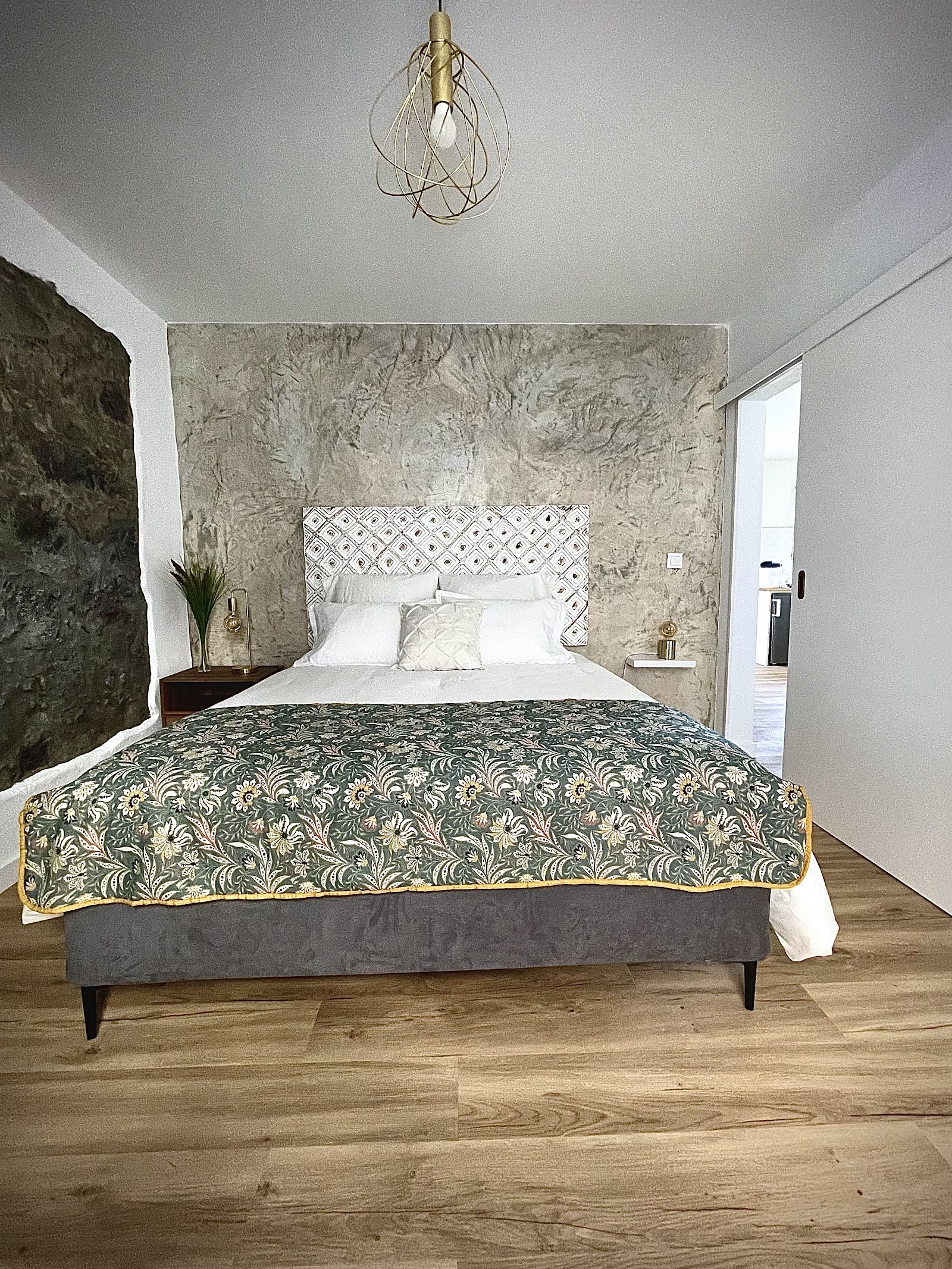 Bright bedroom with volcanic stone feature wall